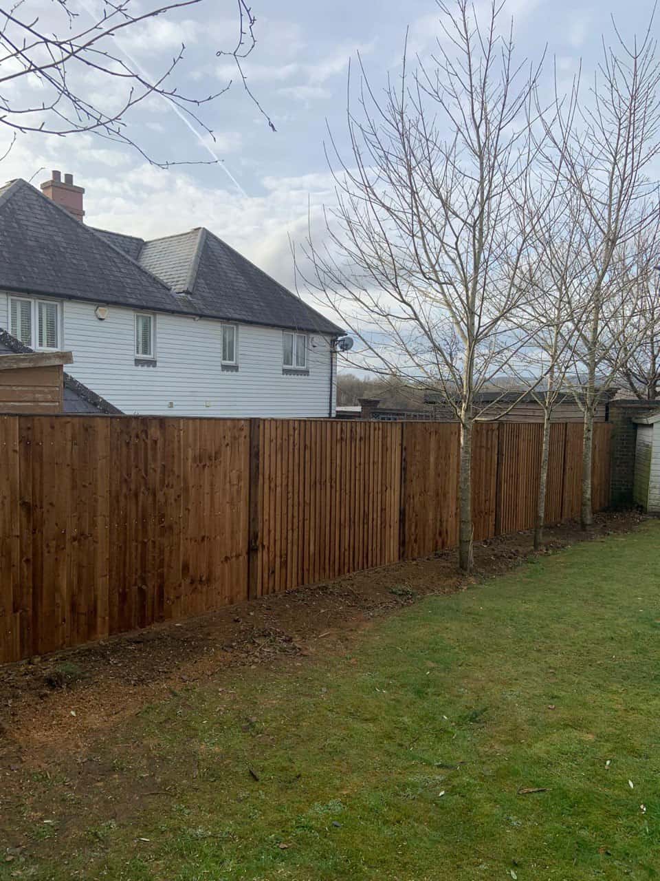 This is a photo of feather edge fencing installed in a residential properties garden by Fast Fix Fencing March