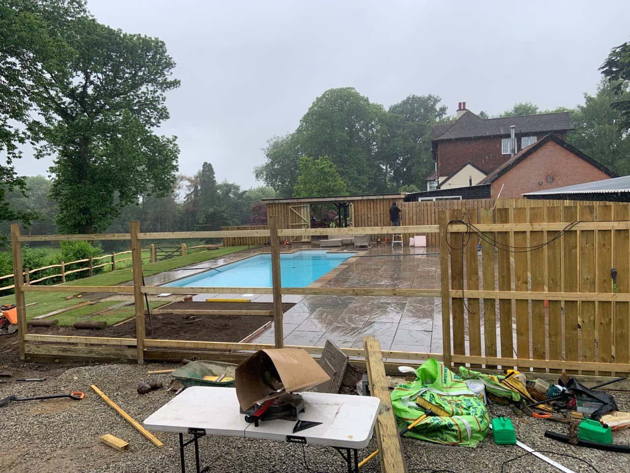 This is a photo of Bespoke custom fencing installed around a swimming pool by Fast Fix Fencing March