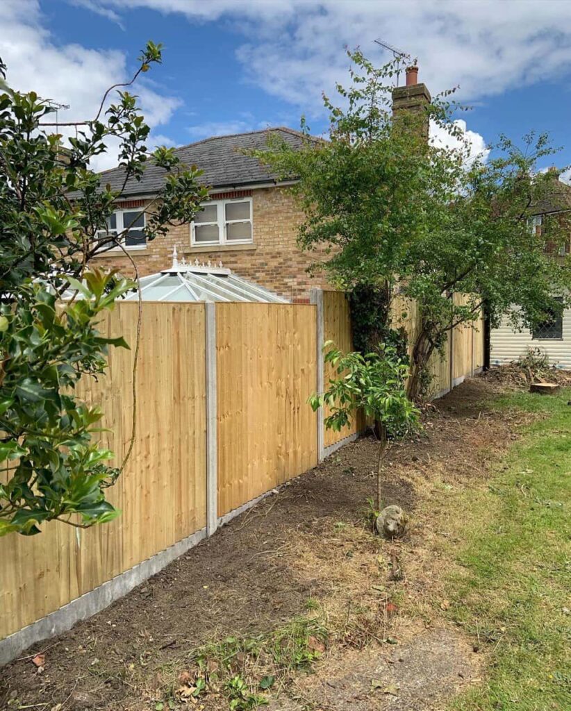 This is a photo of fence panels installed in a residential garden using concrete posts and gravel boards. Installed by Fast Fix Fencing March